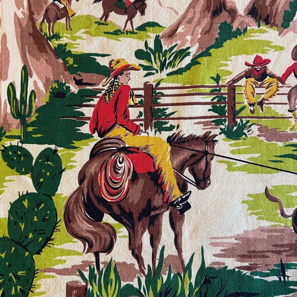 Vintage MCM cotton fabric. 25” x 35”. Cowboys on horses roping cattle.